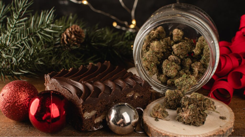 Cannabis flower in a jar surrounded by holiday decorations