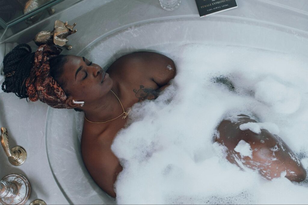 Woman sits in a bubble bath